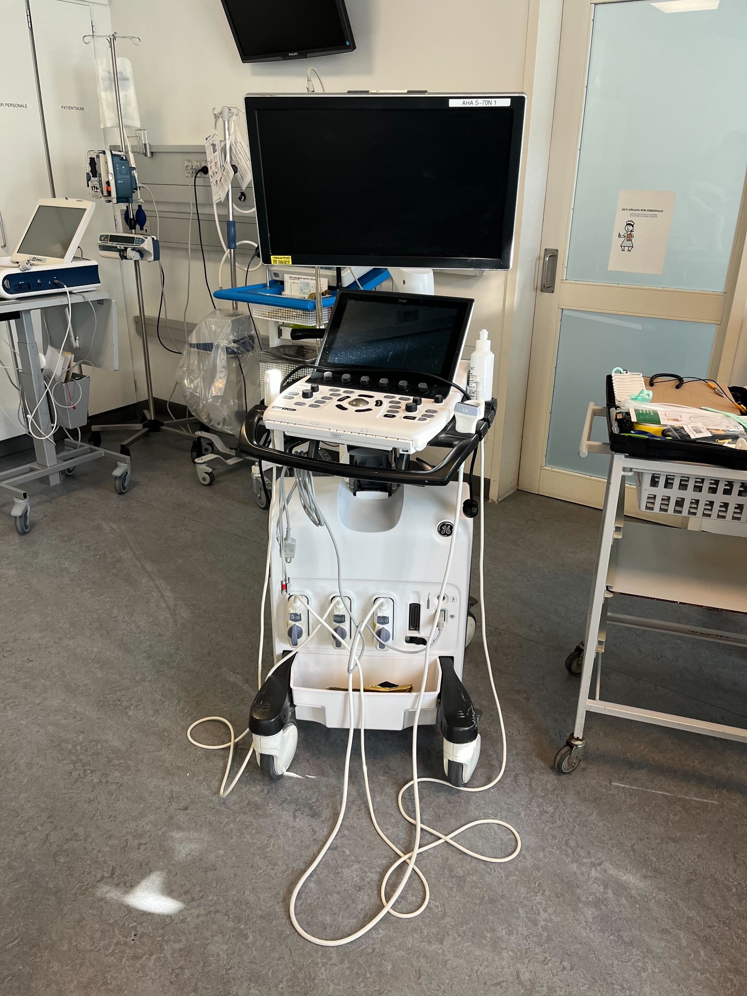 Ultrasound probe cable on the floor beside a machine